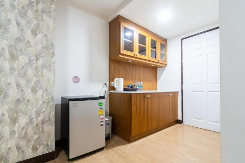 a kitchen with a refrigerator in a room at Peacock De Pai Hotel in Pai