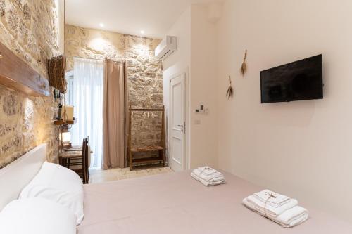 a bedroom with a bed with two towels on it at Suite Torre Arcobasso in Bari
