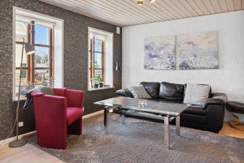 a living room with a couch and a table at City Harbour House in Sønderborg