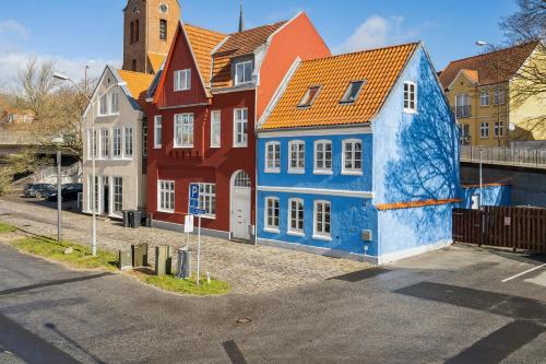 a group of colorful houses in a street at City Harbour House in Sønderborg