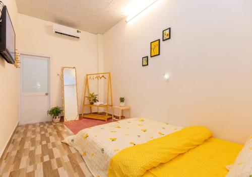 a bedroom with a bed and a mirror on the wall at MTV Homestay Vũng Tàu in Vung Tau
