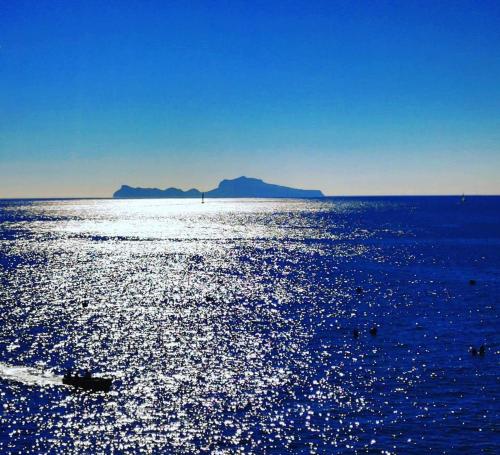 a large body of water with a mountain in the background at Cataldo Guest House in Capri