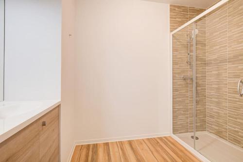 a shower with a glass door in a bathroom at Très belle appartement haut standing in Lacanau-Océan