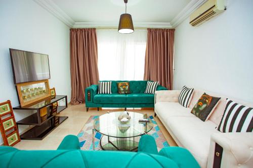 a living room with a couch and a table at Hôtel les Vallons in Abidjan