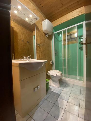 a bathroom with a sink and a shower and a toilet at camping feniglia in Monte Argentario