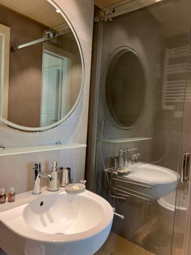 a bathroom with a sink and a mirror at Puleera Boutique Hotel in Giarre