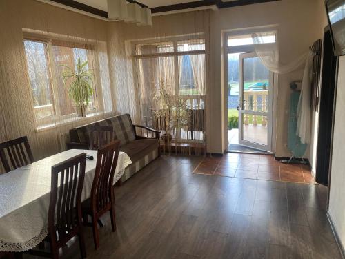 a living room with a couch and a table at Приватна садиба Європа in Solochin
