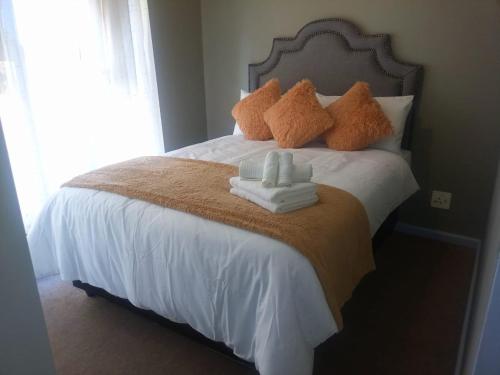 a bedroom with a bed with towels on it at Goshen Place in Cape Town