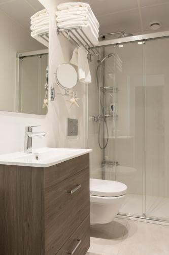 a bathroom with a shower and a sink and a toilet at Apartamentos Martalia Nerja in Torrox