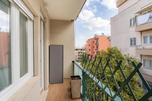 a balcony with a door on a building at White Candle Apt, Close to San Pietro, Gemelli and City Center in Rome