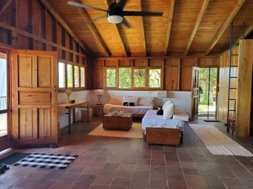a living room with a ceiling fan in a barn at Casa Laguna: Best View In The World in Santa Cruz La Laguna