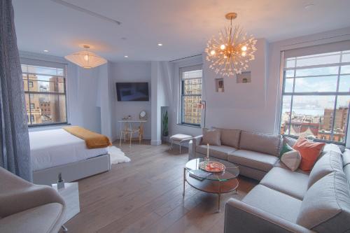 a living room with a bed and a couch at Hotel Belleclaire Central Park in New York