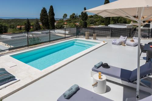 a swimming pool on the roof of a house at Erolidae Villas in Atsoupádhes