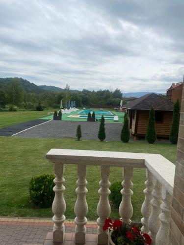 a view of a golf course from a fence at Приватна садиба Європа in Solochin