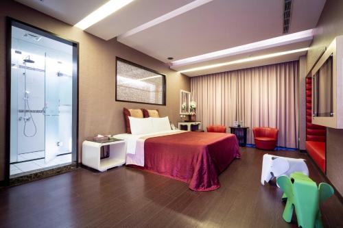 a hotel room with a bed and a large window at Only Love Motel in Xindian