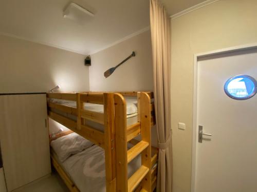 a bedroom with two bunk beds and a window at Marina View in Burgtiefe auf Fehmarn 