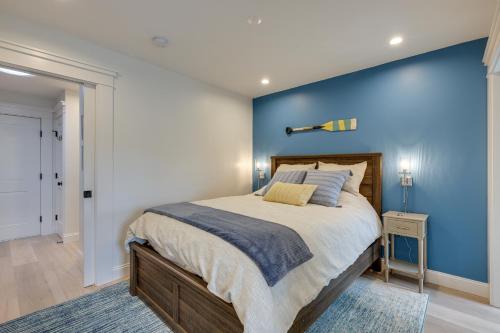 a bedroom with a large bed with a blue wall at Provincetown Vacation Rental Pet Friendly! in Provincetown