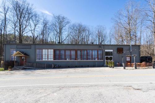 a large gray building with a lot of windows at Worry B Gone in Tracy City