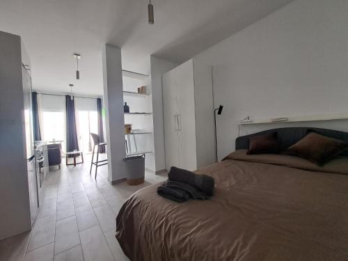 a bedroom with a bed and a room with a kitchen at Sirena Iris in Cotillo