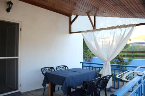 a blue table and chairs on the balcony of a house at House Stamatis in Sarti