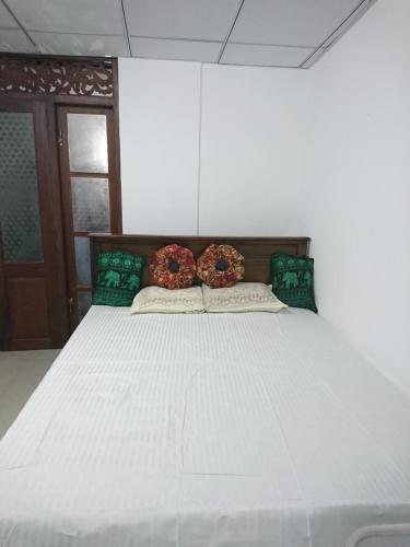 a large white bed with two donuts on it at Shan Villa in Bentota