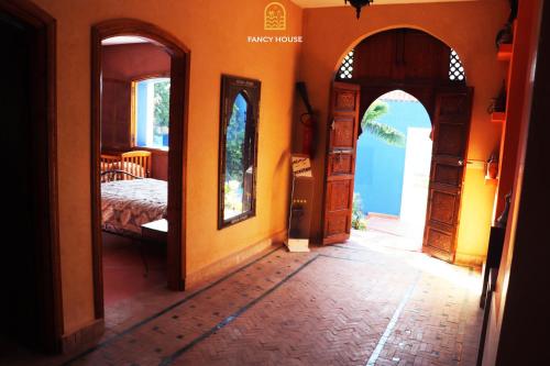 a bedroom with a bed and two open doors at Fancy house in Oualidia