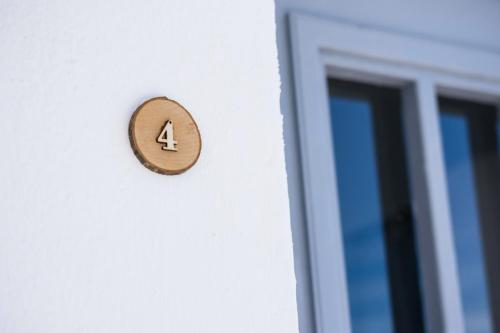 a door knob with the number four on it next to a window at Sarantis apartments in Provatas