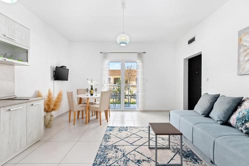 a white living room with a couch and a table at Apartments Stetonn in Kotor