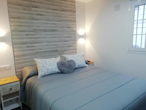 a bedroom with a bed with two pillows at La Casita de Ubrique in Ubrique