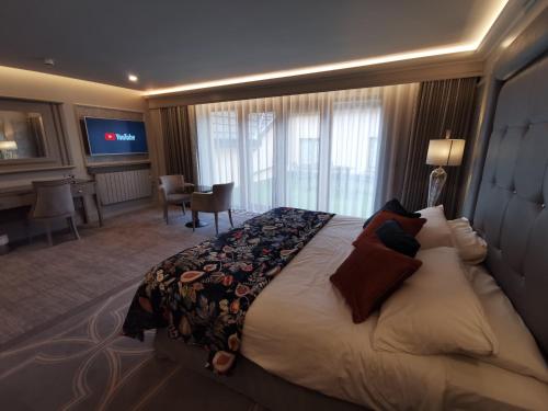 a hotel room with a large bed and a desk at Errigal Country House Hotel in Cootehill