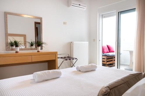a bedroom with a bed and a dresser and a mirror at Naelia in Pastida