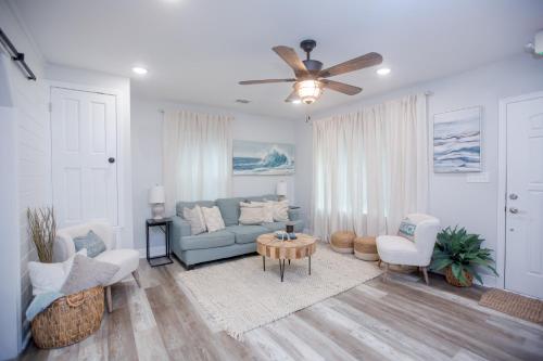 a living room with a couch and a ceiling fan at Captain's Cove in Long Beach