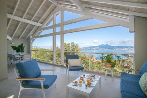 a living room with a view of the ocean at Tangarane in Les Trois-Îlets