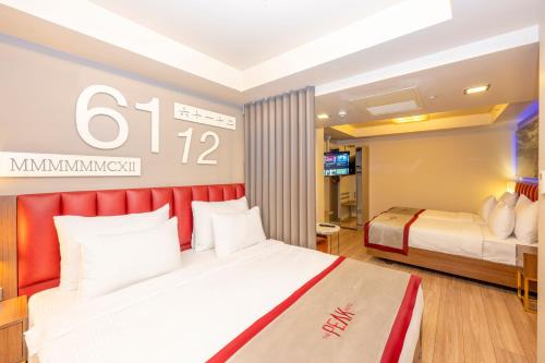 a hotel room with two beds and a television at Ramada By Wyndham Istanbul Pera Taksim in Istanbul