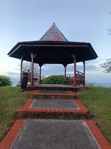 a gazebo sitting on top of a grass field at Appartement Madinina 6 personnes vue sur mer dans village vacances in Sainte-Luce
