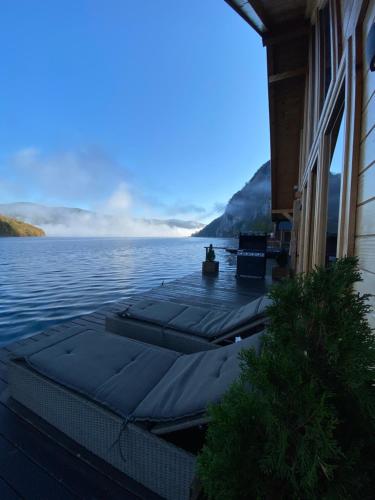 a row of meditation mats on the water next to a building at Floating House Perućac in Perućac