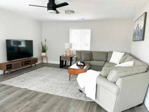 a living room with a couch and a flat screen tv at Modern 3 bed 1 bath Home near downtown and UNL Lincoln in Lincoln