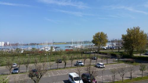 a parking lot with cars parked next to a harbor at FeWo Eggers 1 in Burgtiefe auf Fehmarn 