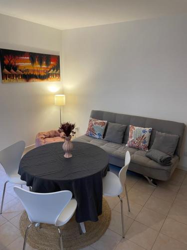 a living room with a table and a couch at Apartment Menaggino in Menaggio