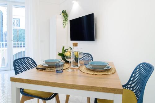 a dining room with a wooden table and chairs at Casa Andreana in Amalfi