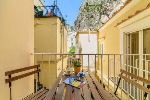 a balcony with a table with a book on it at Casa Andreana in Amalfi