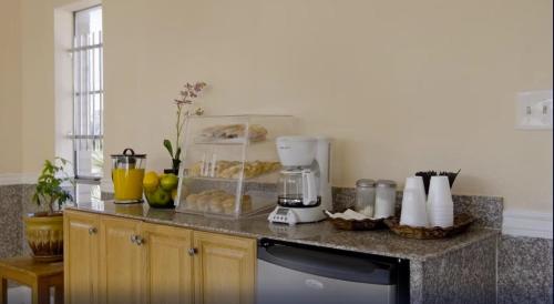 a kitchen with a counter with a blender and pastries at Sunrise Inn in Jasper
