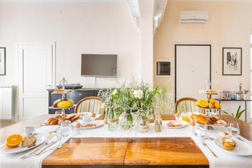 a dining room with a table with food on it at Dimora Le Tre Muse Guesthouse in Lecce