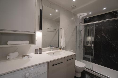 a bathroom with a sink and a shower and a toilet at Jacuzzi maisonette in Sfakia center 'New 2023' in Khóra Sfakíon