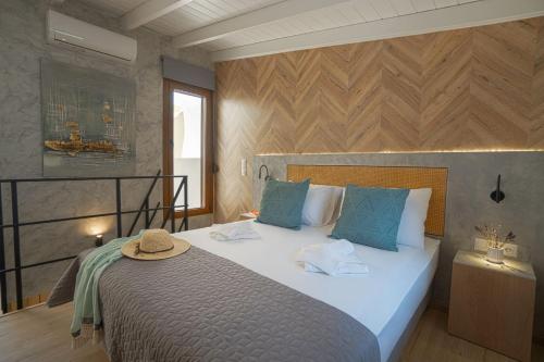 a bedroom with a large bed with a hat on it at Jacuzzi maisonette in Sfakia center 'New 2023' in Khóra Sfakíon