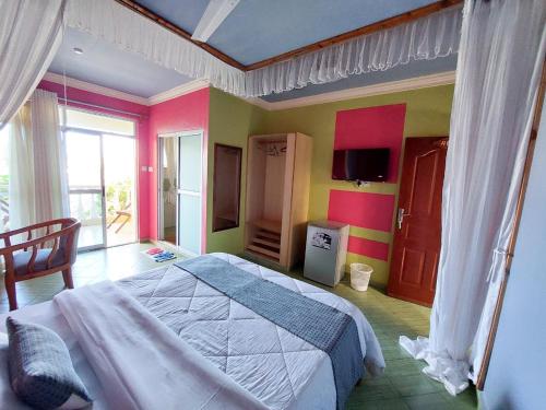 a bedroom with a large bed in a room at Pinebreeze Holiday Resort in Nyali