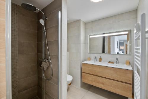 a bathroom with a shower and a toilet and a sink at Agosta Sea View in Porticcio