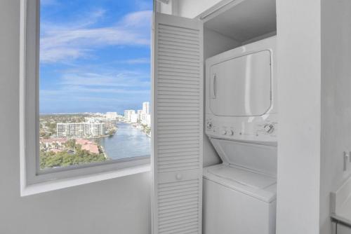 a kitchen with a window with a view of the water at Condo 3 Bedrooms 2 min from the beach in Hallandale Beach