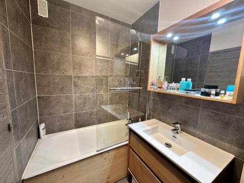 a bathroom with a sink and a shower and a tub at charmant studio à la Rosière in Montvalezan