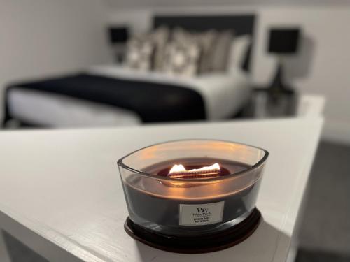 a candle on a table in a living room at Tettenhall Village Townhouse in Wolverhampton
